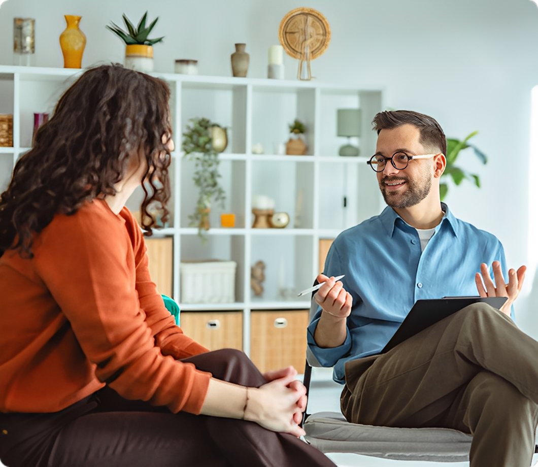 Two people talking in a bright room